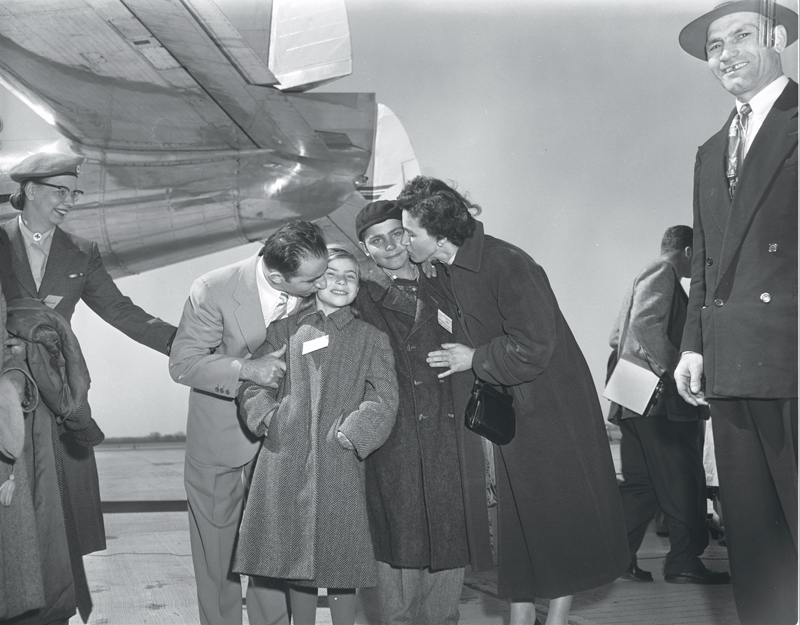 Greek family reunites at Malton Airport, 1955. Image no. ASC02581.