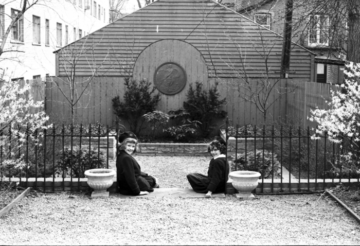 Historic photo from Saturday, May 4, 1963 - Two girls seated on either side of gate to garden - rear of 21 Lowther Avenue  in The Annex
